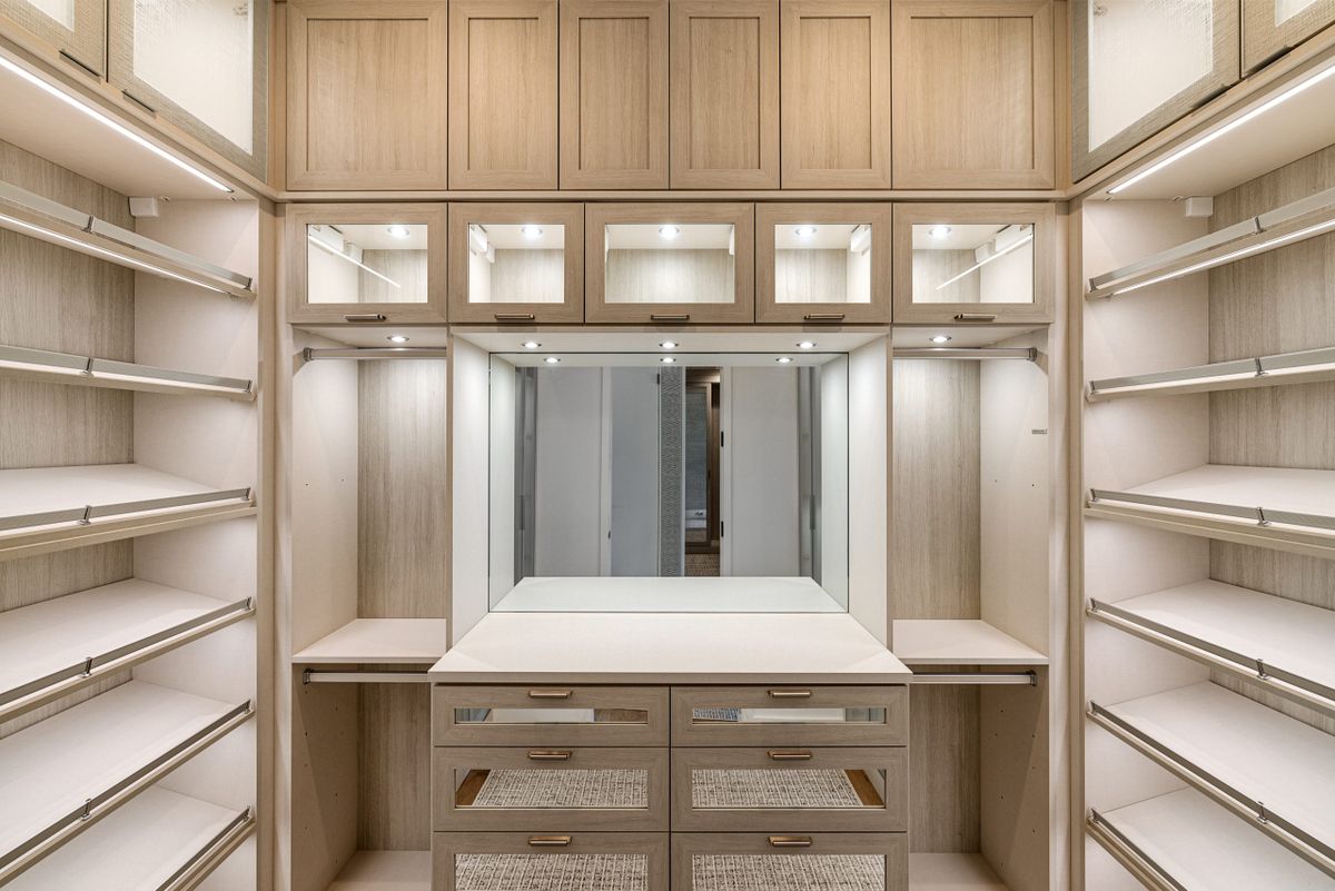 A modern walk-in closet with built-in shelving